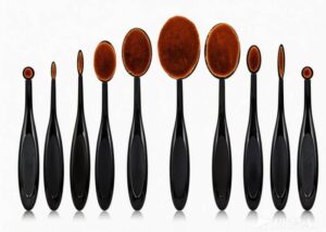 A 10-piece professional oval makeup brush set with black ergonomic handles and dense synthetic bristles for wholesale and private label.